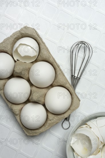 White eggs in packaging with beaters