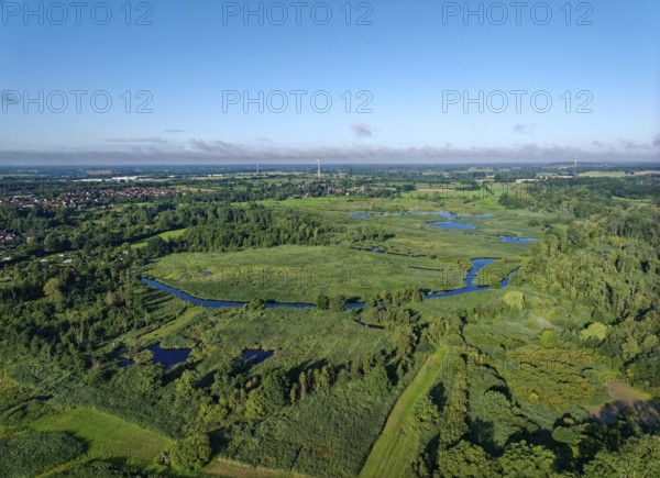 Water surfaces of the Trave and vegetation in the Brenner Moor. Aerial view. The Brenner Moor is a salt marsh, FFH area, in the Trave lowlands near Bad Oldesloe. Schleswig-Holstein, Germany