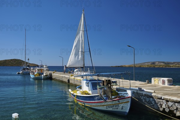 Boats are moored along a pier on the calm blue water, Analipsi, Maltezana, Astypalea, Astipalea, Astipaleia, Dodecanese, Greek Islands, Greece