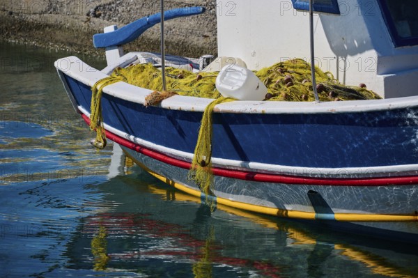 A blue fishing boat with a fishing net lies on the water in the harbour, Analipsi, Maltezana, Astypalea, Astipalea, Astipaleia, Dodecanese, Greek Islands, Greece