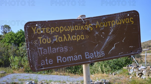 A weathered sign points to the ancient Roman baths, Analipsi, Maltezana, Astypalea, Astipalea, Astipaleia, Dodecanese, Greek Islands, Greece