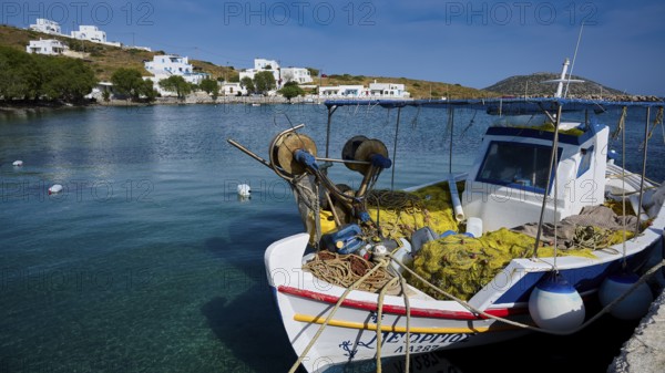 A fishing boat in the calm waters of a harbour with white buildings in the background, Analipsi, Maltezana, Astypalea, Astipalea, Astipaleia, Dodecanese, Greek Islands, Greece