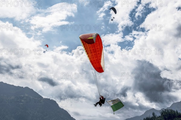 Paragliding tandem flight canton Vaud flag, Interlaken, Switzerland