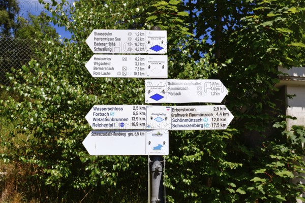 Hiking trail signpost in Forbach, Black Forest, Germany showing directions and distances to nearby destinations