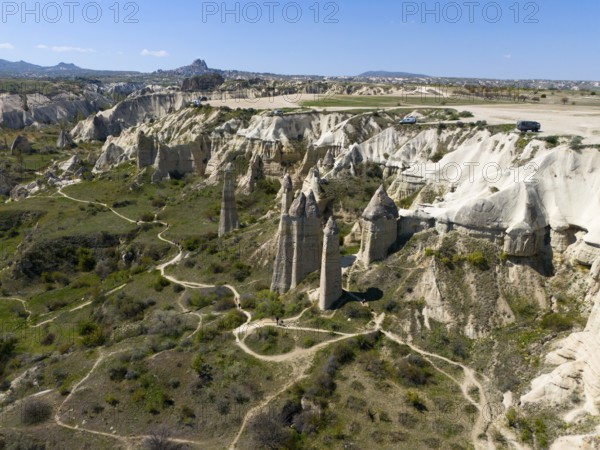 A hilly landscape with iconic rocks and roads in Cappadocia, aerial view, Love Valley, Göreme National Park, Göreme Tarihî Millî Parki, Nevsehir Province, Nevsehir, Cappadocia, Cappadocia, Cappadocia, Cappadocia, Central Anatolia, Turkey