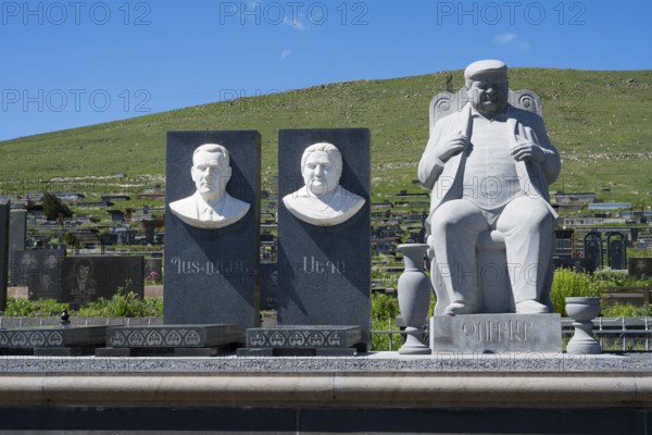 Stone busts and figure on a cemetery in front of a green hill and blue sky, Gyumri, Alexandropol, Leninakan, Shirak Province, Armenia