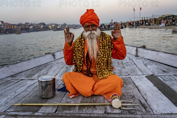 Sadhu with trident on boat, Katesar, Mughalsarai, Uttar Pradesh, India