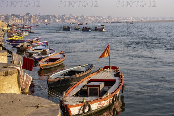 River Ganges with boats and Varanasi in the background, Shivala, Varanasi, Uttar Pradesh, India
