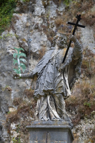 Sculpture of St Nepomuk in front of a rock face, Weltenburg, district of Kelheim, Lower Bavaria, Germany