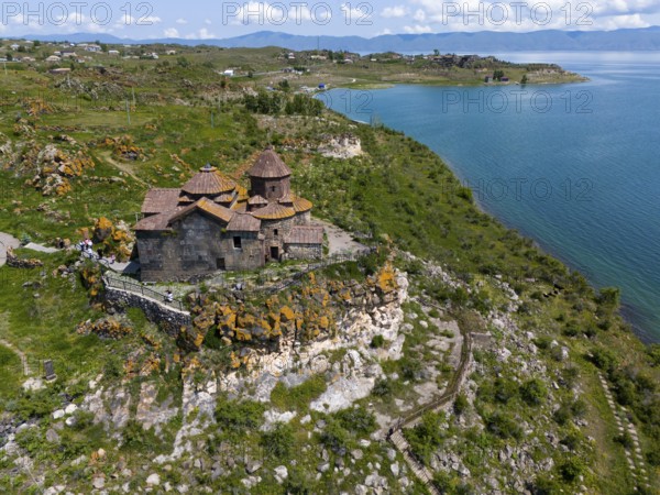 Church perched above a magnificent lake with a panoramic view of the surrounding countryside, aerial view, Hajrawank Monastery, Hayravank, Lake Sevan, Gegharkunik Province, Armenia