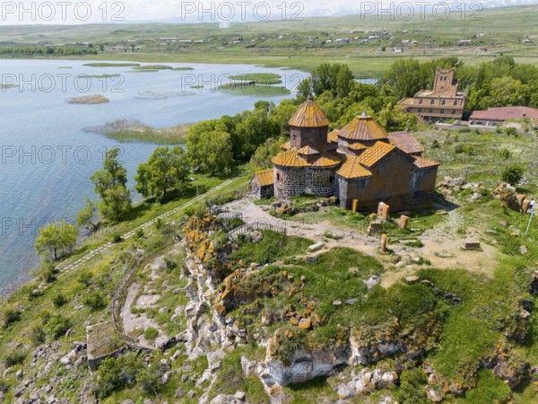 Historic church on a cliff with a surrounding green landscape and a lake, aerial view, Hajrawank Monastery, Hayravank, Lake Sevan, Gegharkunik Province, Armenia