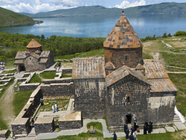 Stone monastery church with picturesque view of the lake and the mountains in the background, aerial view, Sevanavank Monastery, Sevan Monastery, Gegharkunik Province, Armenia