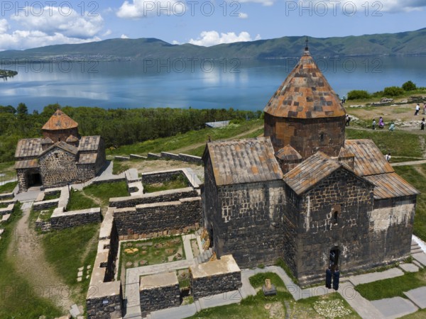 Historic stone monastery with a lake and mountain panorama under a cloudy sky, aerial view, Sevanavank Monastery, Sevan Monastery, Gegharkunik Province, Armenia