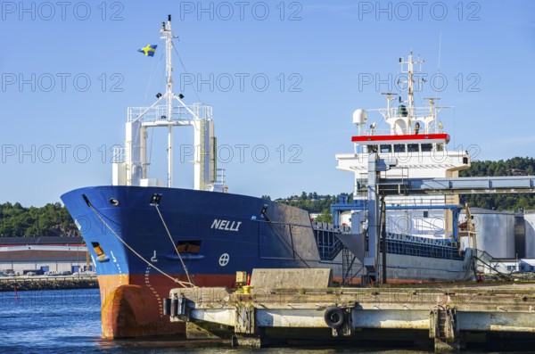 Industrial harbour structures and cargo ship NELLI in the port of Uddevalla, Bohuslän, Västra Götalands län, Sweden, for editorial use only