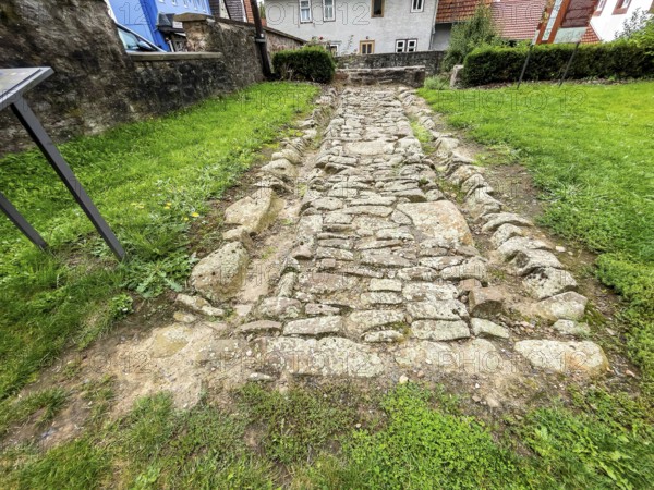 Archaeological find of original small section with old stones from historic trade route between Frankfurt am Main and Leipzig, Steinau an der Straße, Hesse, Germany, relocated to secure protected site in Steinau an der Straße