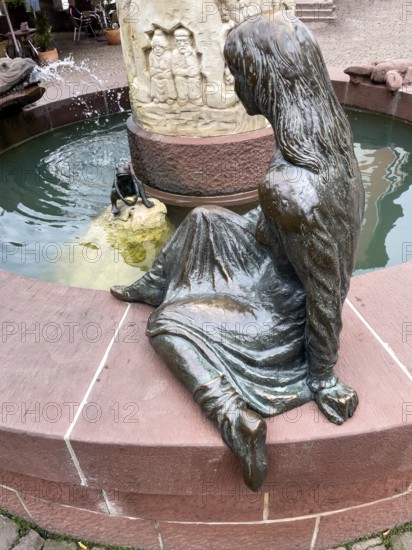 Sculptures figures of princess and frog holding golden ball representation from fairy tale the frog king by Brothers Grimm at in fairy tale fountain in Steinau an der Straße, Steinau an der Straße, Hesse, Germany