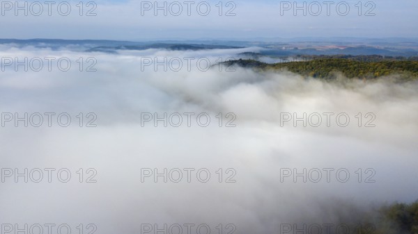 Bird's eye view of aerial view of high fog lying over valleys of low mountain ranges, Germany