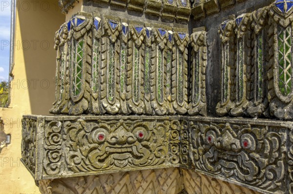 Relief work bas-relief by stonemason on outer wall of Buddhist monastery, Koh Lanta, Thailand