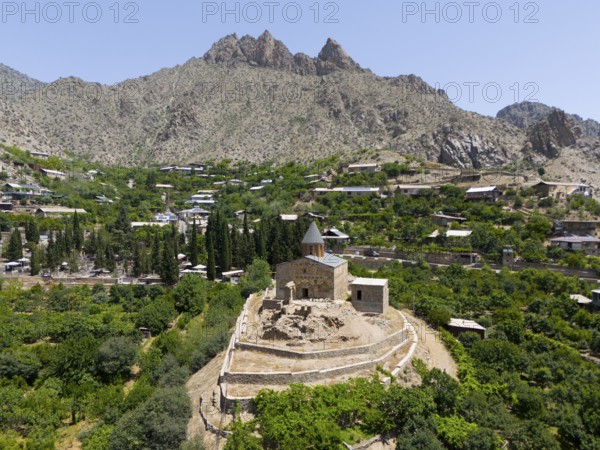 Historic mountain church surrounded by lush vegetation and impressive mountains, aerial view, St John's Church, Surb Howhannes, Meghruvank Monastery, Basilica, Meghri, Syunik Province, not far from the border with Iran, Armenia, Asia