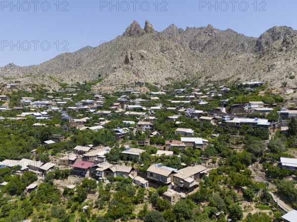 Traditional mountain village with scattered houses and hills surrounded by mountains, aerial view, Meghri, Syunik province, not far from the border with Iran, Armenia, Asia