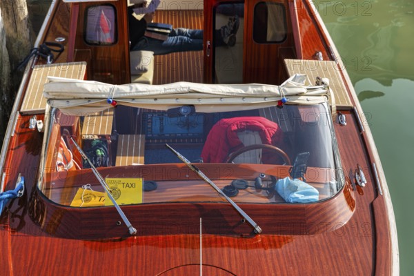 Water taxi, taxi boat, view from above, captain taking a break, Murano, group of islands in the lagoon of Venice, Italy