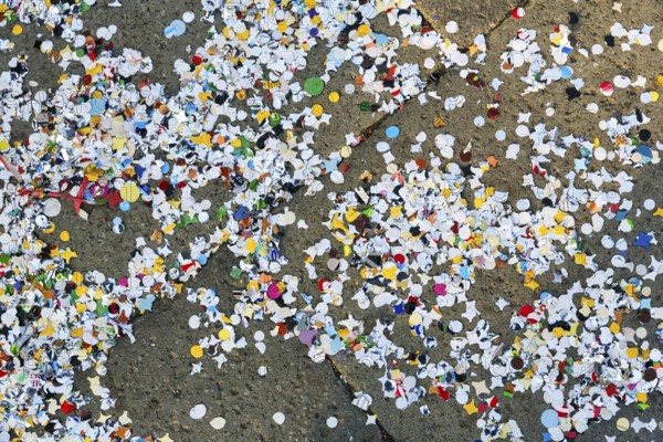 Confetti on asphalt, full-size, symbolic image, waste, environmental pollution, Carnival in Venice, Italy
