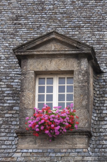 Dormer window with glazing bars in a historic house, floral decoration, old town of Guingamp, Département Côtes-d'Armor, Brittany, France