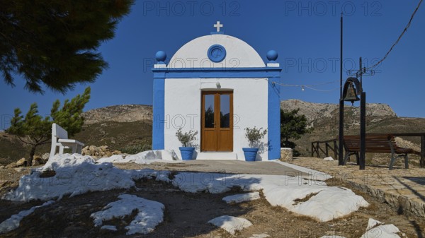 White chapel with blue façade and cross in a mountainous setting under a clear sky, Panagia tou Paleokastro, Church of the Old Fortress, Chapel, Panagia Kasteli, Lepides, Leros, Dodecanese, Greek Islands, Greece