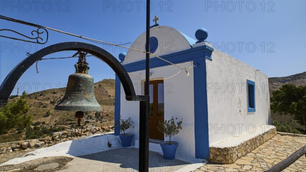 Small white-blue chapel in the countryside with bell in the foreground and blue sky in the background, Panagia tou Paleokastro, Church of the Old Fortress, Chapel, Panagia Kasteli, Lepides, Leros, Dodecanese, Greek Islands, Greece