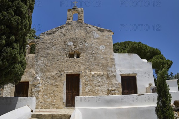 Stone church façade with steeple, simple and rustic architecture, basilica, church, Agios Theologos, Leros, Dodecanese, Greek Islands, Greece