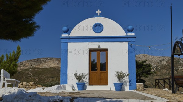 White chapel with blue façade and cross in a peaceful, mountainous landscape, Panagia tou Paleokastro, Church of the Old Fortress, Chapel, Panagia Kasteli, Lepides, Leros, Dodecanese, Greek Islands, Greece