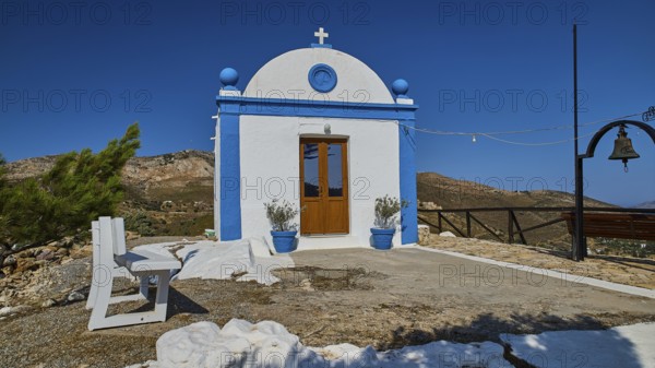White chapel with blue façade and cross in an open, mountainous landscape, Panagia tou Paleokastro, Church of the Old Fortress, Chapel, Panagia Kasteli, Lepides, Leros, Dodecanese, Greek Islands, Greece
