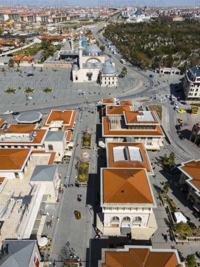 Bird's eye view of an urban landscape with red roofs and a mosque in the background in sunny weather, aerial view, pedestrian zone, Mevlânâ Museum, Mevlana, landmark, Mausoleum of Mevlânâ Dschalal ad-Din Rumi, Konya Sultan Selim Camii, Konya, Central Anatolia, Turkey
