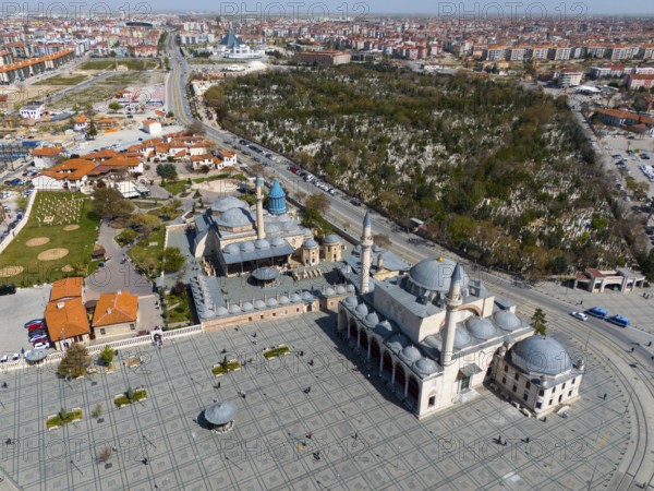 Mosque and surrounding green spaces next to an extensive urban landscape, aerial view, Mevlânâ Museum, Mevlana, landmark, Mausoleum of Mevlânâ Jalal ad-Din Rumi, Konya Sultan Selim Camii, Konya, Central Anatolia, Turkey