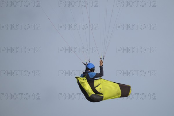 A paraglider or paraglider in front of a blue sky, near Hvide Sande, North Sea, Denmark