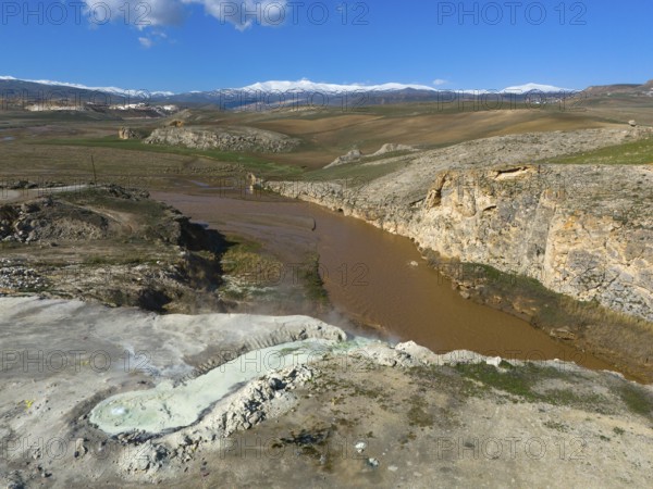 Vast landscape with brown river and rocky gorge under blue sky and white clouds, aerial view, thermal springs, Diyadin, Murat River, Agri Province, Agri, Eastern Anatolia, Turkey