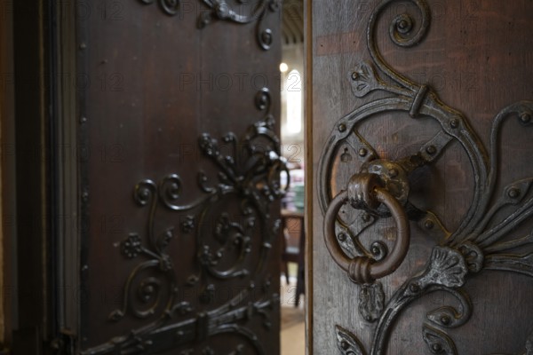 Solid wooden door with ornate iron fittings and door knocker, St Mary Abbot Church, Kensington, London, England, Great Britain