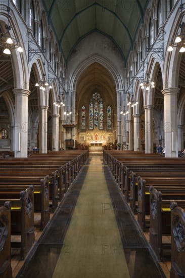 Neo-Gothic church interior with high arches and wooden benches, St Mary Abbot Church, Kensington, London, England, Great Britain