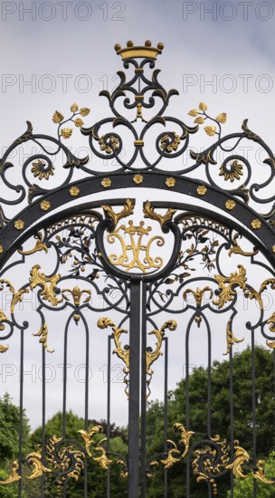 Magnificently decorated iron gate with golden ornaments and crown, Kensington, London, England, Great Britain