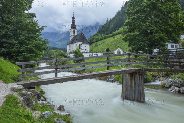 St Sebastian in Ramsau in Berchtesgadener Land with rain clouds after heavy rain