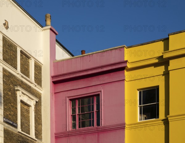 Colourful building facades in pink, yellow and white, blue sky, Portobello Road, Notting Hill, London, England, Great Britain