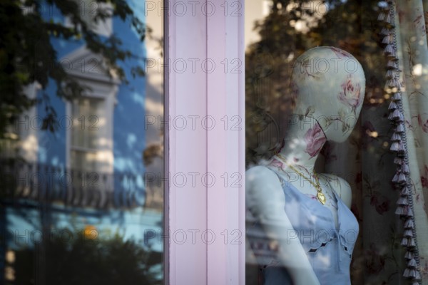 Mannequin in floral pattern, reflection in shop window, Portobello Road, Notting Hill, London, England, Great Britain