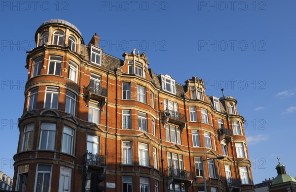 Large red brick building with bay windows and balconies, Notting Hill, London, England, United Kingdom