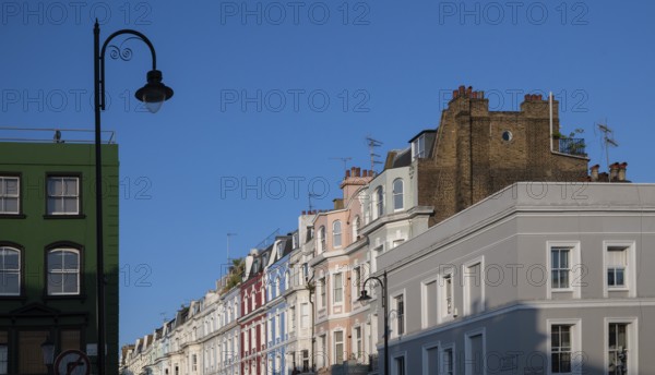 Terraced houses, townhouses with different, colourfully painted facades under a blue sky, Portobello Road, Notting Hill, London, England, Great Britain