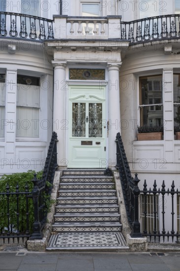 House entrance with mint green door, black and white staircase and decorative wrought iron railings, Ladbroke Grove, Notting Hill, London, England, Great Britain