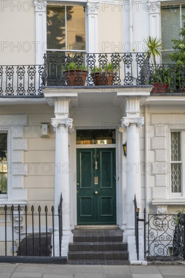 Classicist house façade with columns and green door, Kensington, London, England, Great Britain