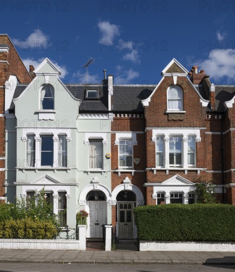 Two Victorian terraced houses with contrasting facades, Kensington, London, England, United Kingdom