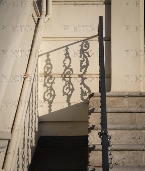 Shadow of an artistically decorated banister on a house wall, Notting Hill, London, England, Great Britain