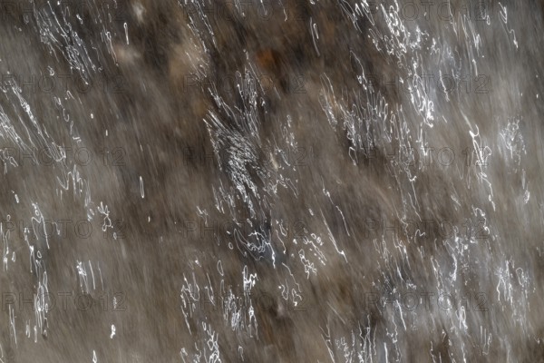 Close-up of moving water with a pattern of light and shadow, light trails, long exposure, North Sea, Denmark