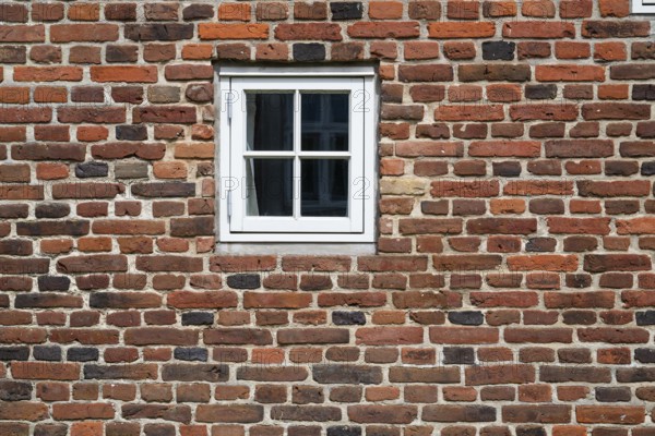 Close-up of a brick wall with a small white window, Old Town, Ringkøbing, Ringkøbing Fjord, Denmark
